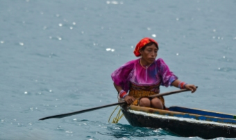 A Kuna Indian selling her wares from a canoe